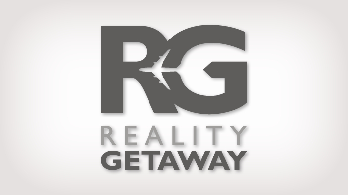 Reality Getaway Logo Design - Capital Letters R and G in a slate gray, bold, sans-serifed typeface. The silhouette of an airplane makes up the whitespace between the letters.